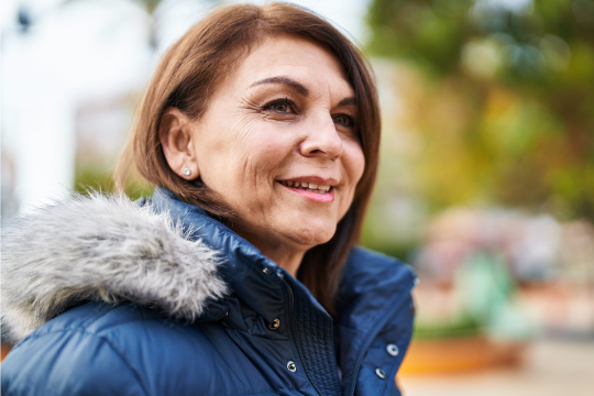 Smiling adult woman in winter coat.